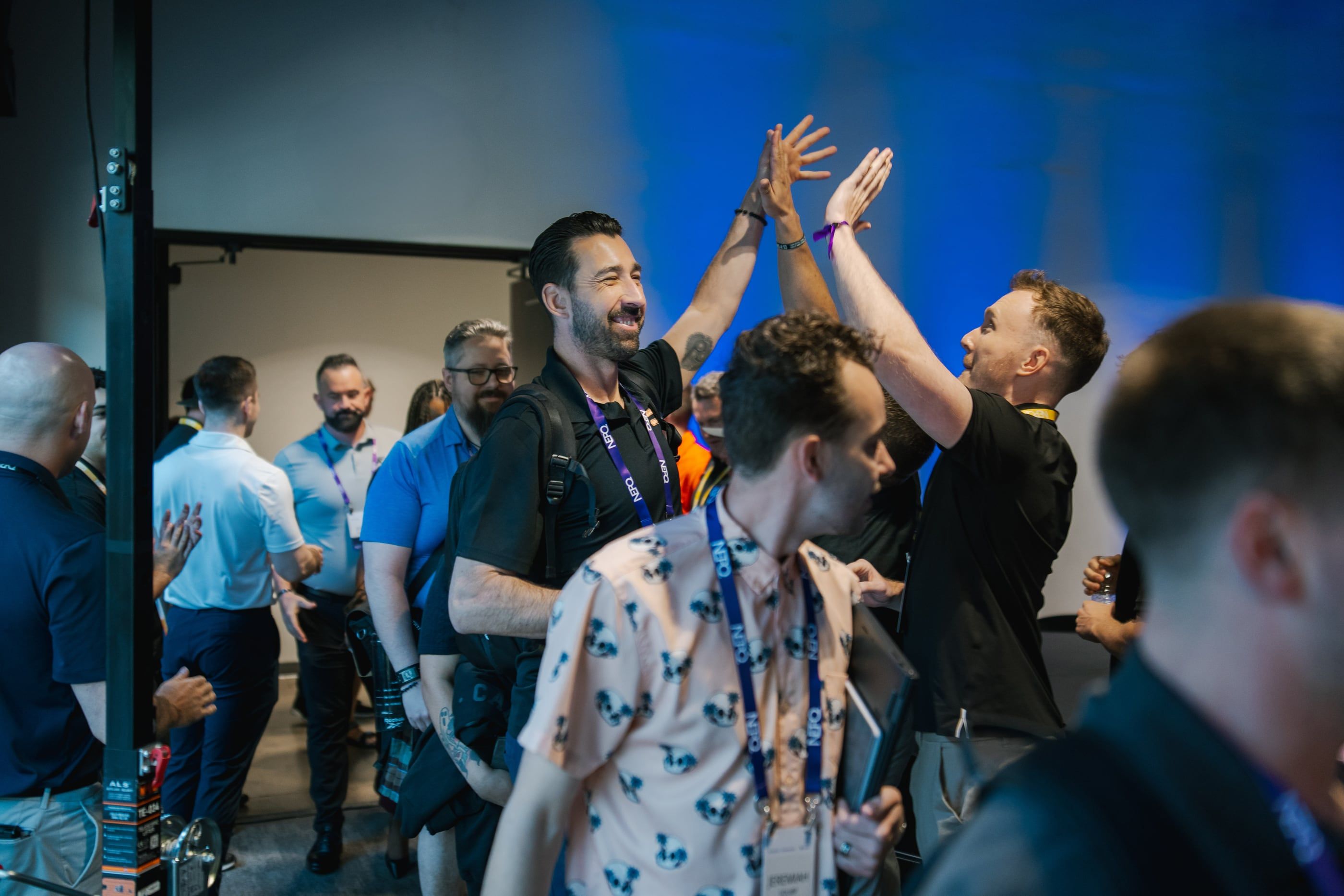 Attendees trading high-fives as they walk into the room